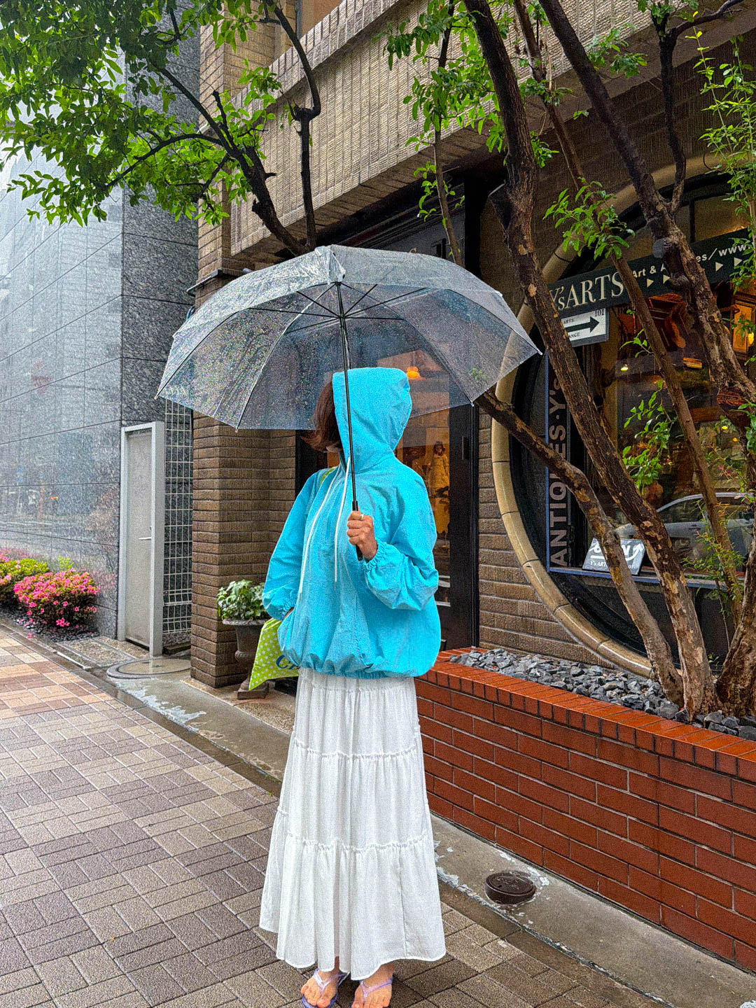 Woman in anorak and jeans on a rainy day